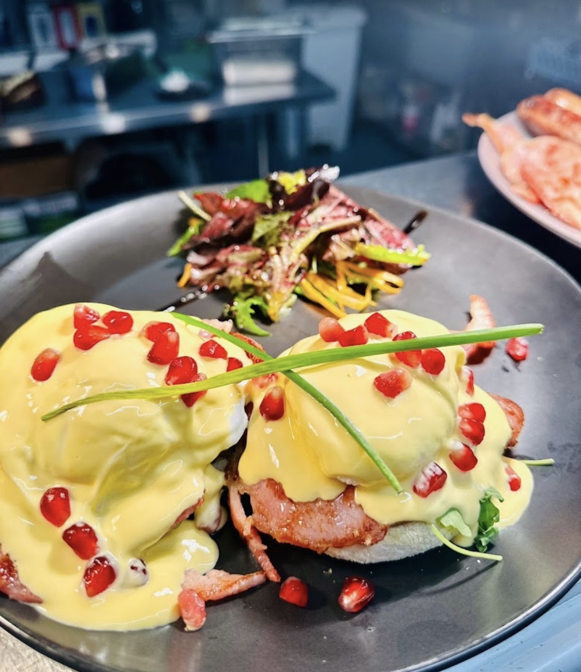 Eggs benedict with hollandaise and pomegranate