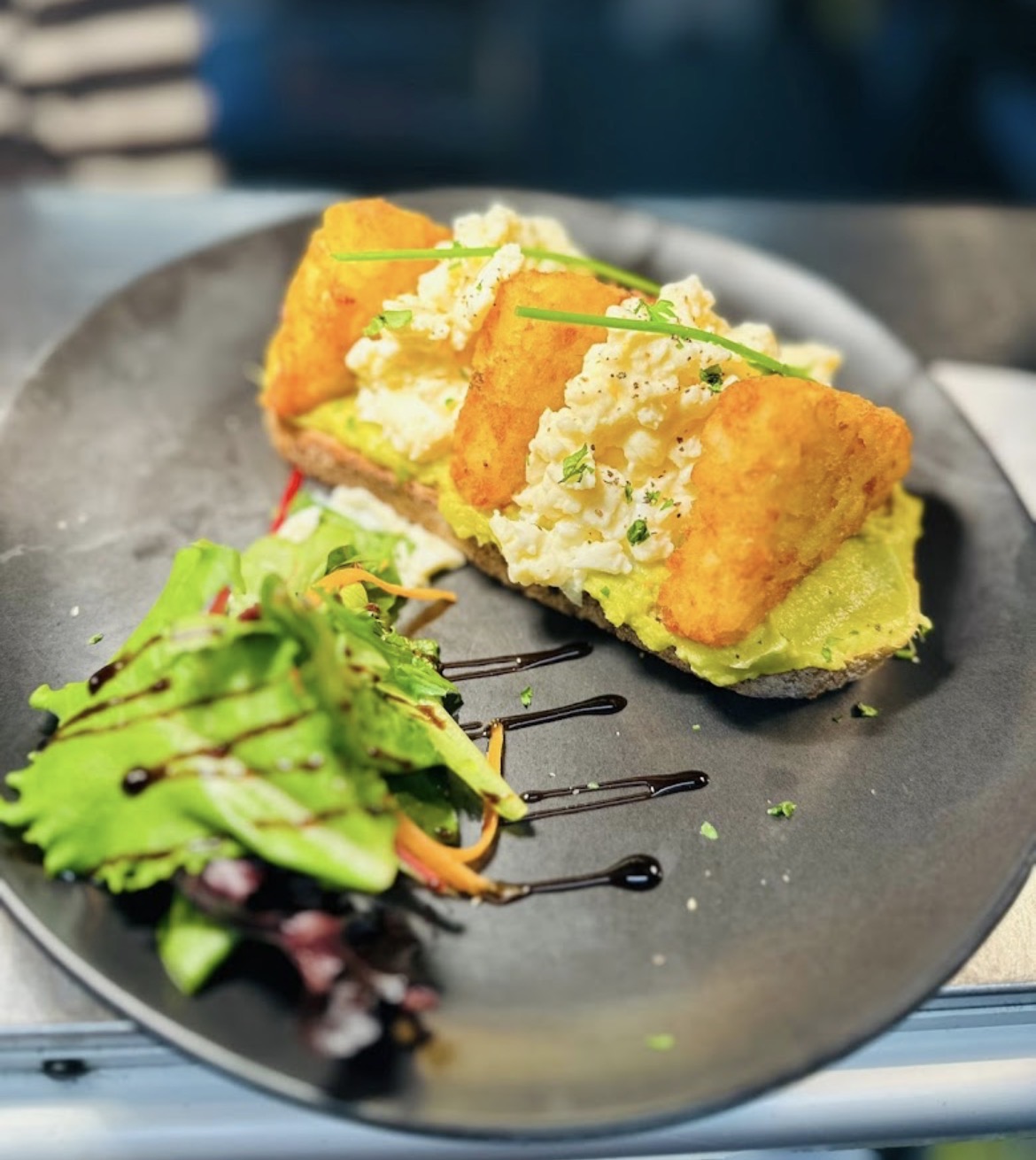 Avocado toast with scrambled egg and hash browns